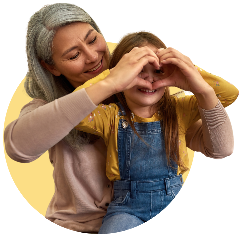 foster carer pay & Foster carer and young girl making a heart shape with their hands