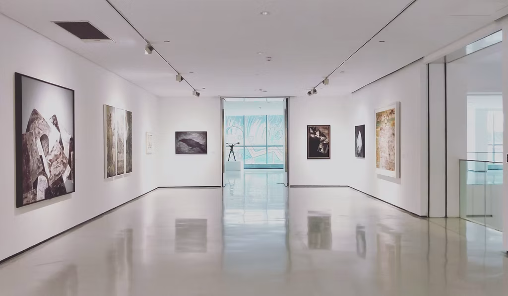 Bright gallery space with framed artwork on white walls